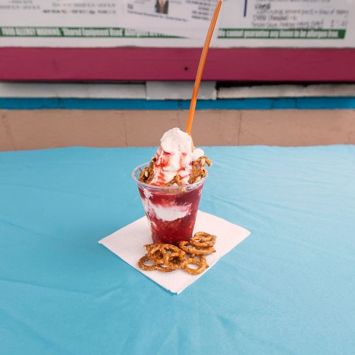 Strawberry sundae with pretzels on a blue tablecloth
