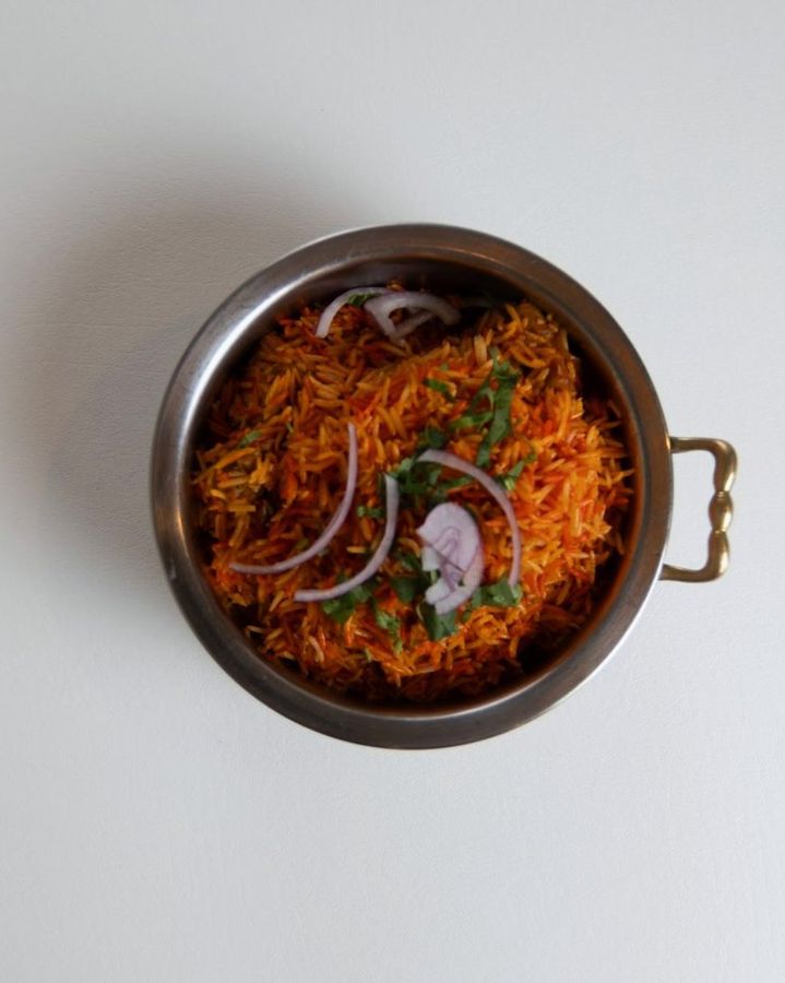 Biryani in a copper serving bowl