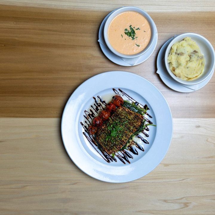 Plated entrée with balsamic drizzle, soup and a side