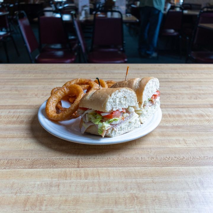Sandwich with onion rings on a diner plate