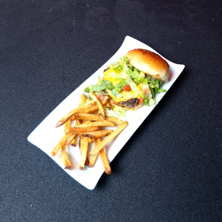Burger and fries on a long white plate