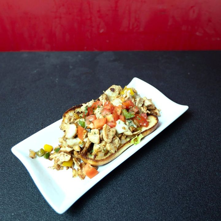 Loaded flatbread on a long white plate