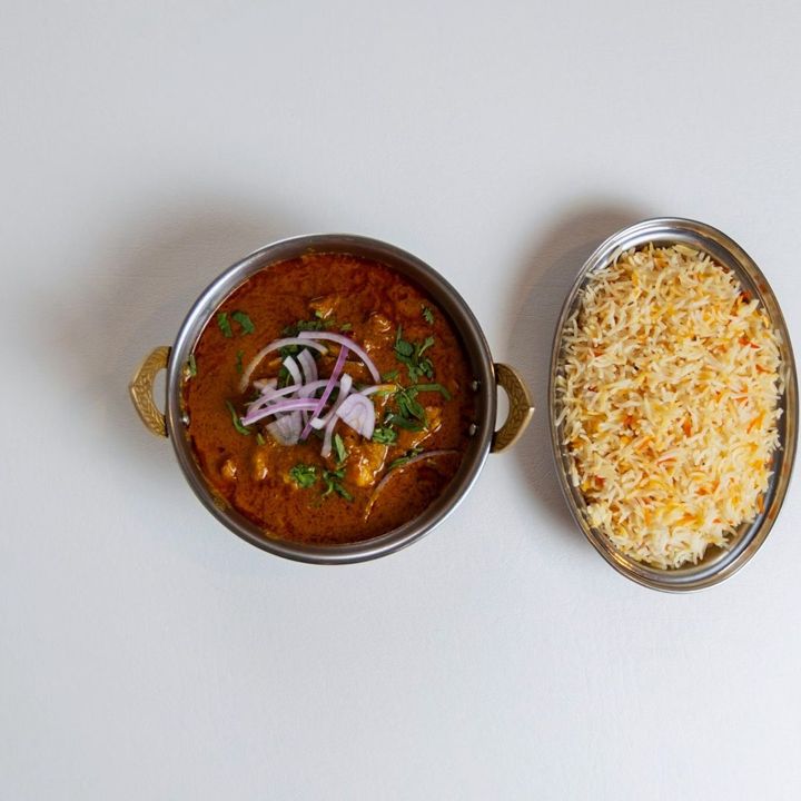 Curry and rice in copper serving bowls