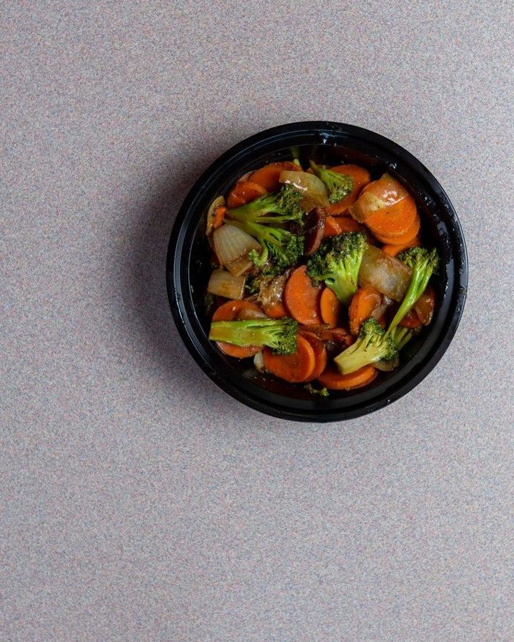 Vegetable stir-fry in a black bowl