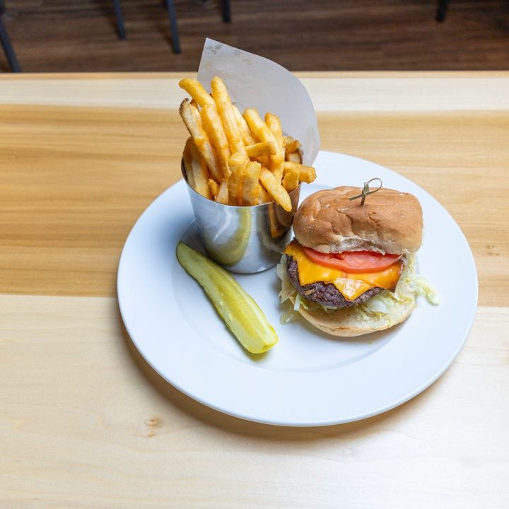 Burger with fries and a pickle