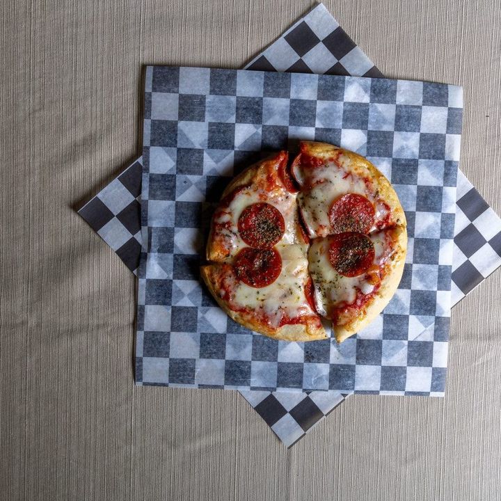 Pepperoni pizza on checkered paper