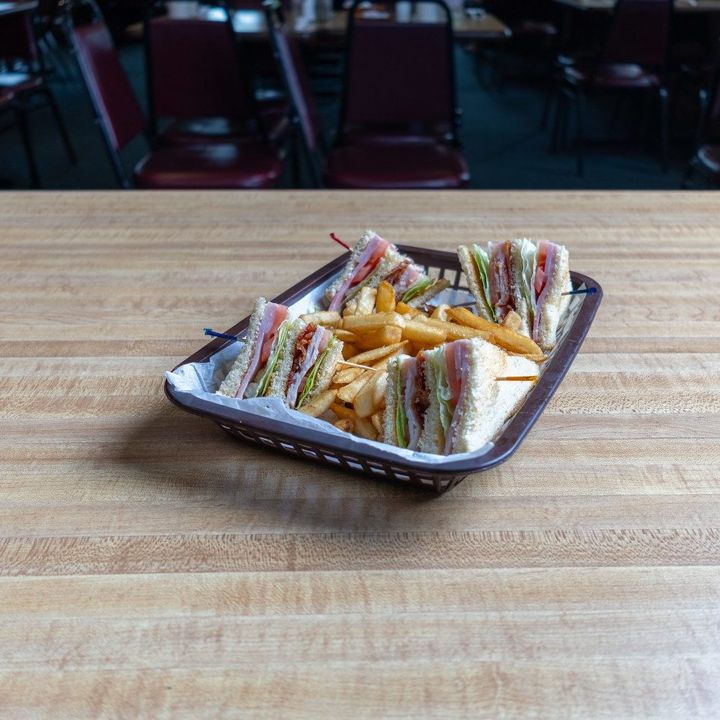 Club sandwich and fries in a basket